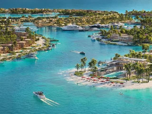 The island marina and lagoon, with yachts moored among the villas.